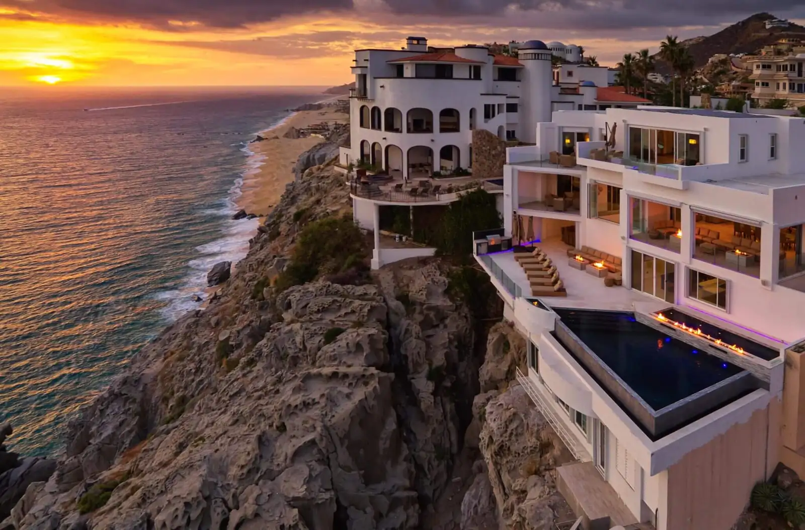 Sunset view over luxury cliffside villas in Los Cabos