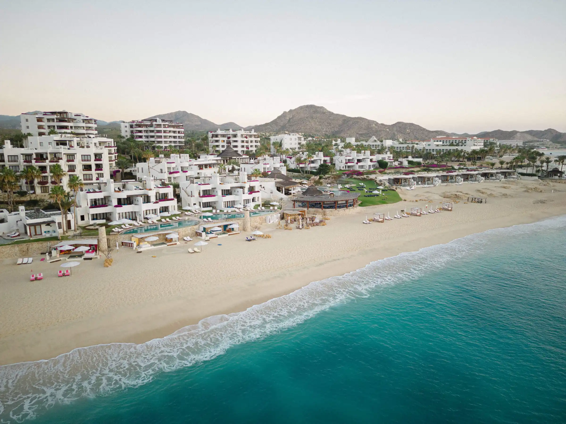 Oceanfront resort and palm-lined beach in Los Cabos
