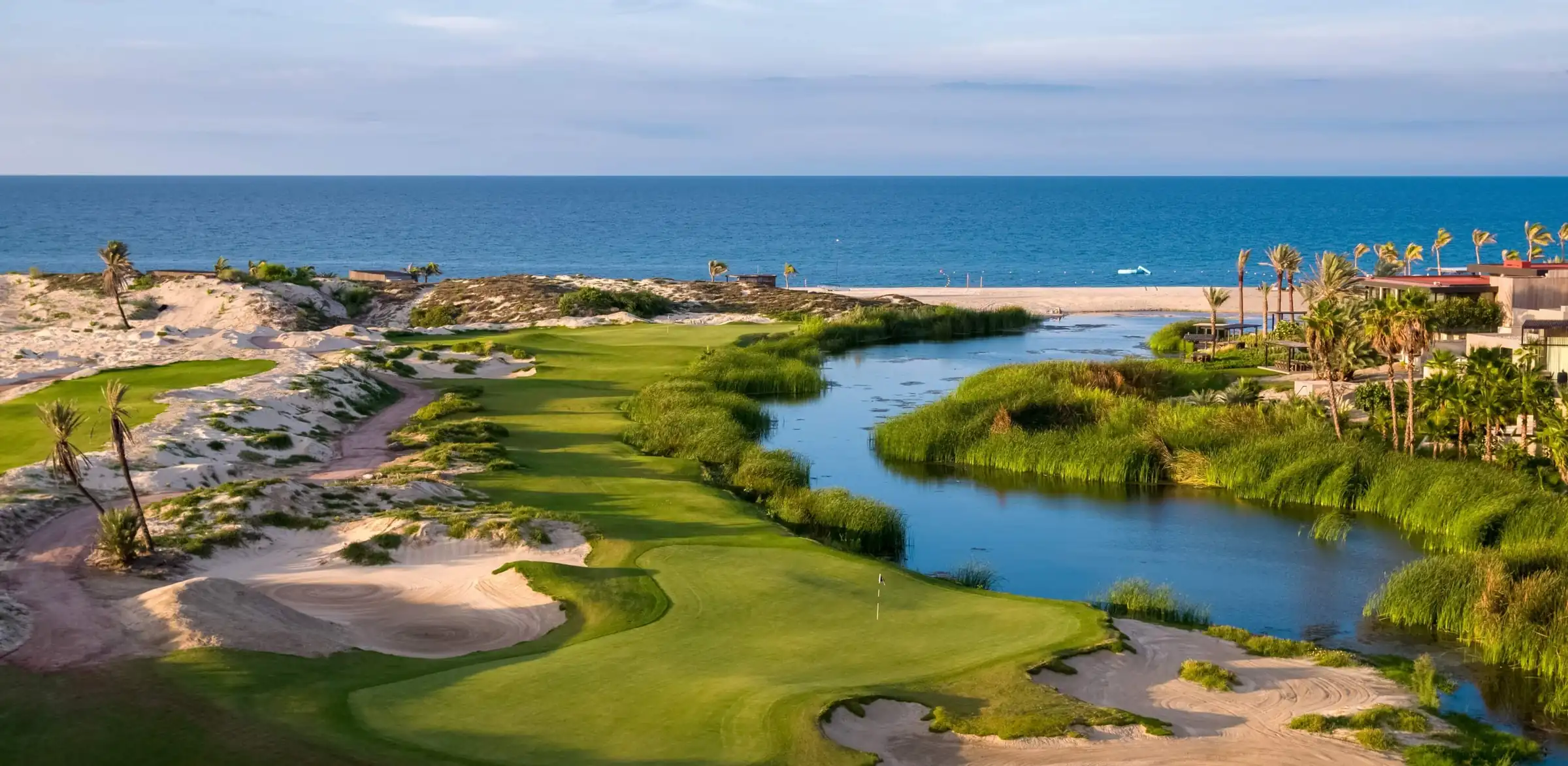 Golf greens and tranquil coastal lagoon along the Baja California Sur beach