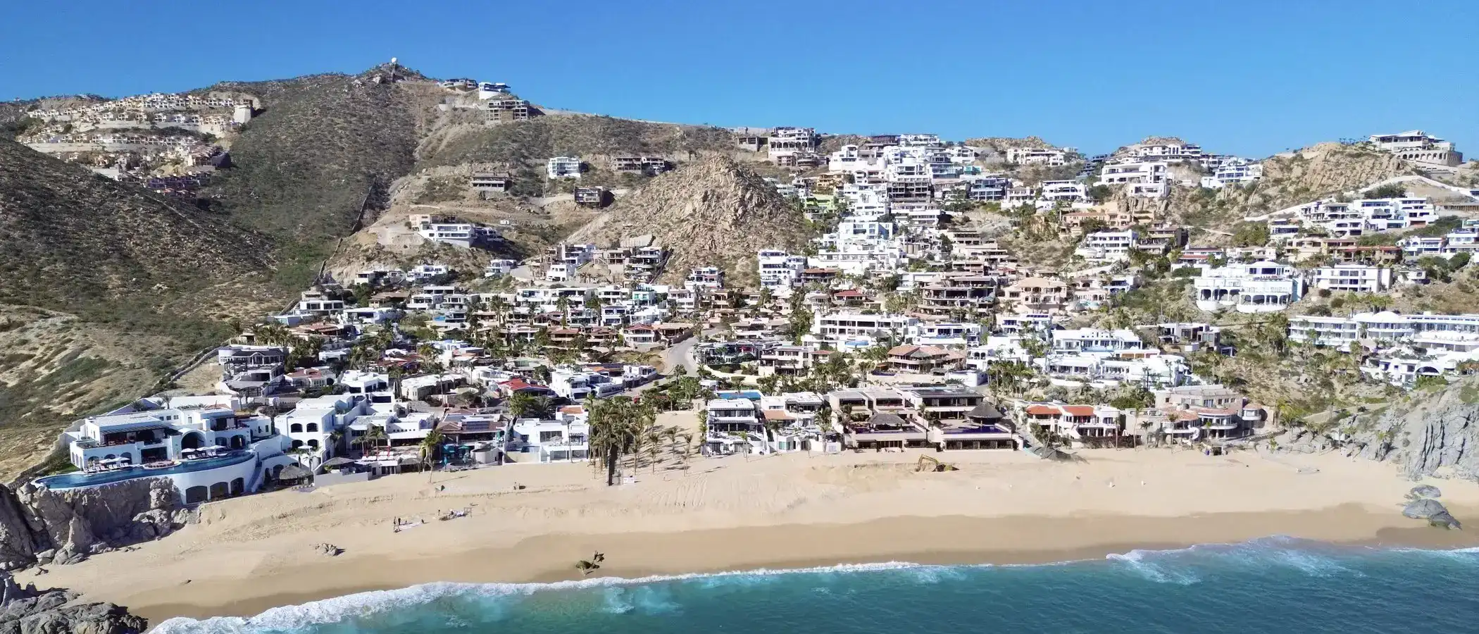 Pedregal Cabo San Lucas: Aerial of the Pedregal headland and Pacific beach. Pedregal Cabo San Lucas: Wide establishin...